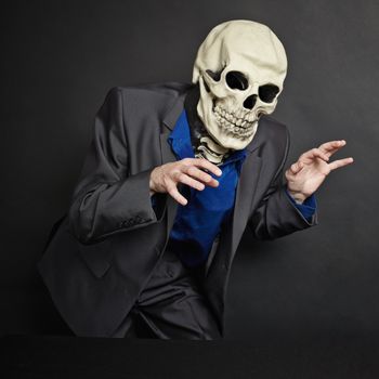 The terrifying person in a skeleton mask is stolen on dark background