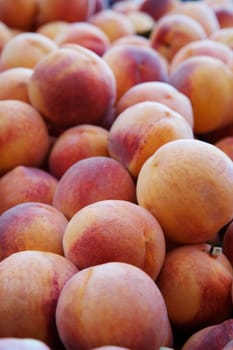 Pile of peachs diminishing to soft focus at the market