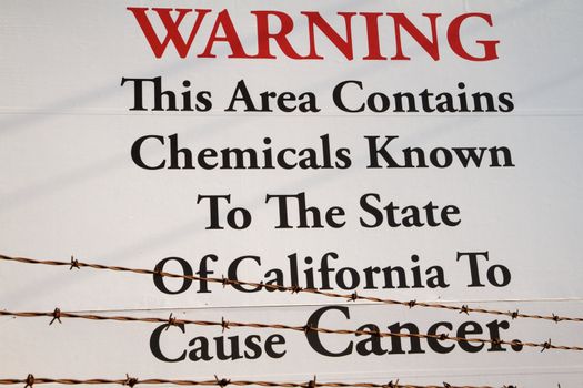 Toxic waste site warning of cancer behind barbed wire