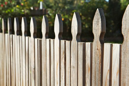 Plain carved wood fence win perspectie dimishing to soft focus