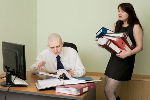 The bookkeeper and the secretary on a workplace at office