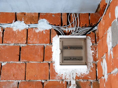 electrical installations, safety fuses box on red brick wall