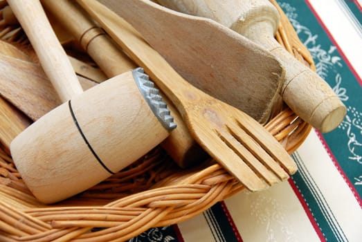 wooden kitchen equipment, meat hummer and scoops closeup on table