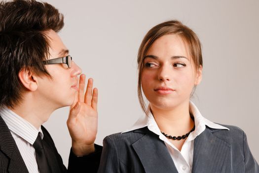 Businessman whispering to his partner