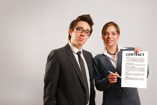 Two business partners holding a printed contract