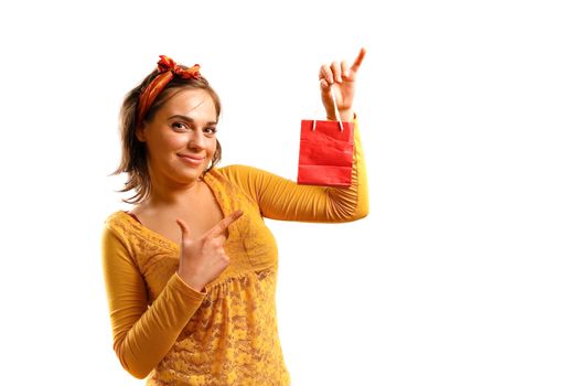 Modern looking young woman holding shopping bag