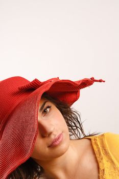 Modern looking young woman wearing a red hat