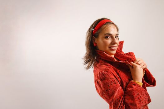 Modern looking young woman wearing a red jacket