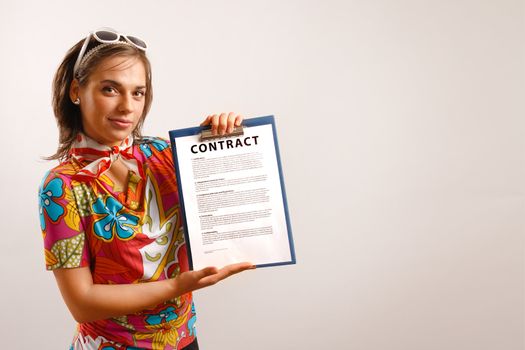 Modern looking young woman holding a printed contract