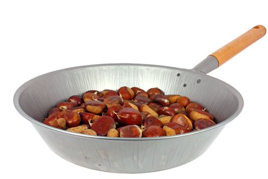 Raw chestnuts in a pan isolated on white