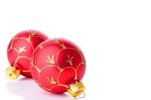 Two red glass christmas decorations on a white background.
