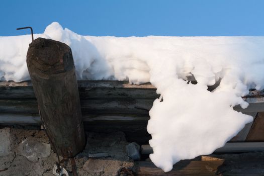 Wooden roof, drooping snow, winter, sunny, blue sky