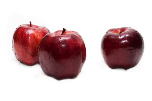 Three red apples, in droplet grow insulated on white background