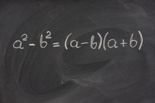 simple mathematical formula handwritten with white chalk on a blackboard with strong eraser smudge patterns