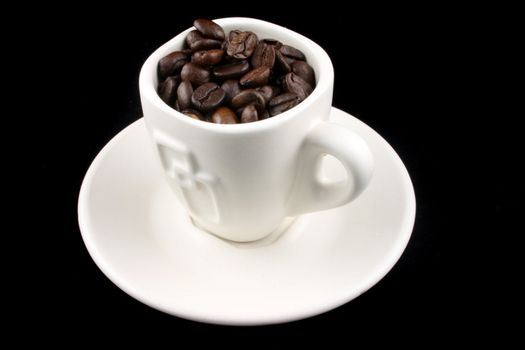 Coffee Cup with coffee beans in it on a Black Background
