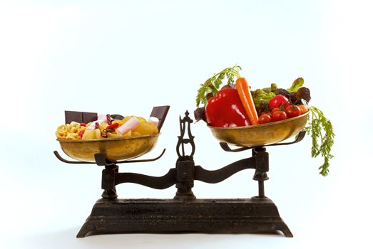 Healthcare concept: healthy and unhealthy food on vintage scales