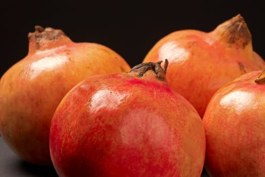 Closeup of fresh pomegranates on black background