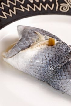 Closeup take of  a pickled rollmops herring