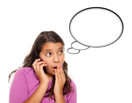 Shocked Hispanic Teen Aged Girl on Cell Phone with Blank Thought Bubble Isolated on a White Background - Contains Clipping Paths.