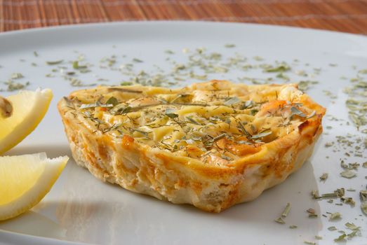 Heart shaped salmon quiche served with herbs