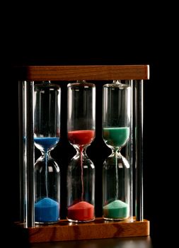 A triple hourglass measuring different periods of time
