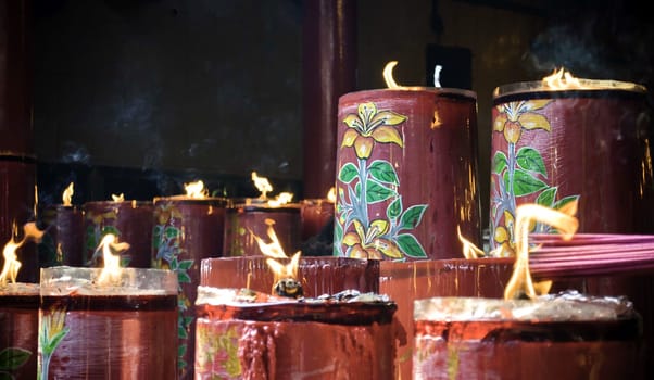 Sacred big red candle in buddhist temple