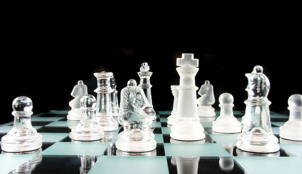 Glass Chess Pieces on a Frosted Glass Chess Board

