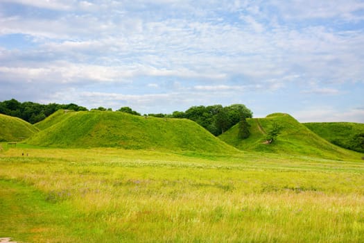 green hill blue cloudy sky