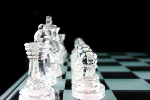 Glass Chess Pieces on a Frosted Glass Chess Board

