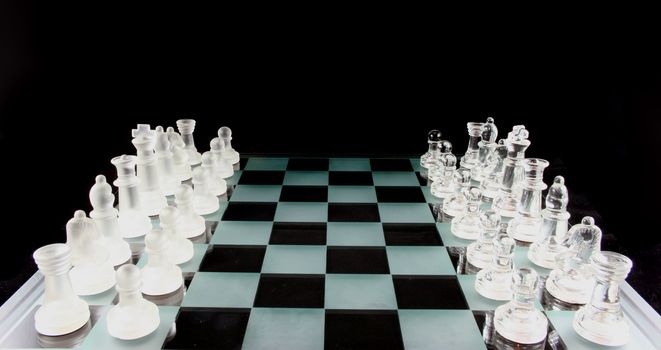 Glass Chess Pieces on a Frosted Glass Chess Board

