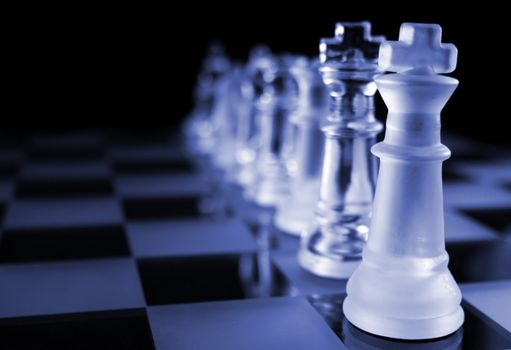 Glass Chess Pieces on a Frosted Glass Chess Board

