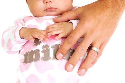 father placing hand on new baby girl with wedding ring visible