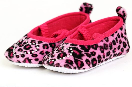 a pair of pink and red baby shoes with a crystal heart on