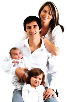 portrait of a young family with their newborn baby and daughter smiling