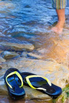 Rubber slippers on the stony sea coast