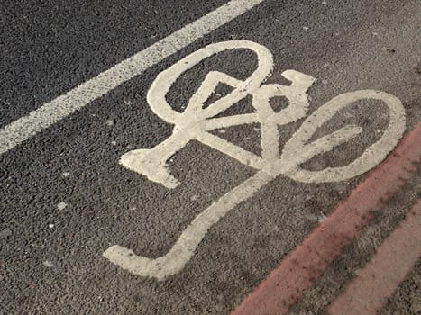 Bicycle lane sign painted on a street