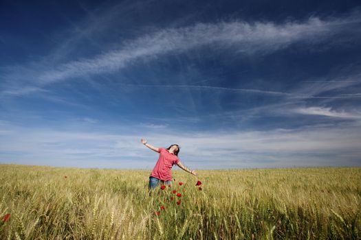 beautiful young woman with pink shirt happy in the nature