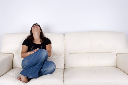 beautiful young woman with black shirt sitting in white sofa smiling