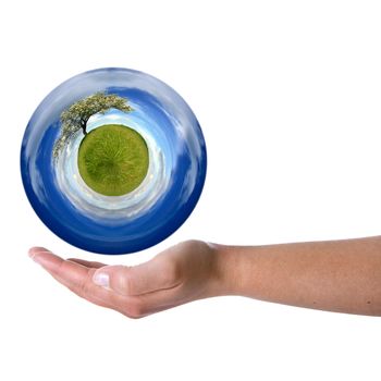 woman hand holding sphere with spring landscape - Environmental concept