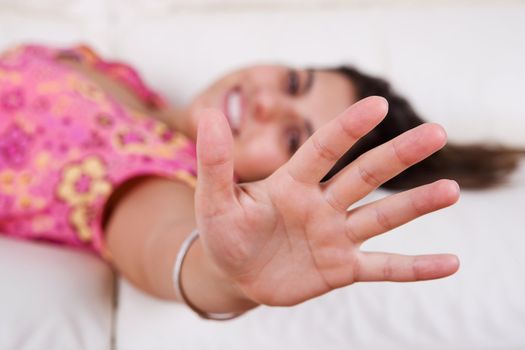 beautiful young woman with hand wide open. focus on the hand.