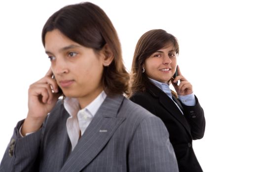 two businesswoman holding mobile phones. Focus is on the back model.