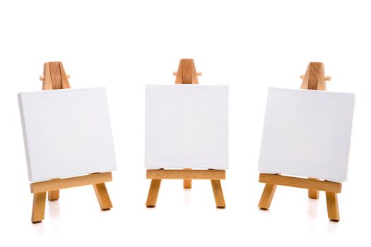 three empty white painting canvas