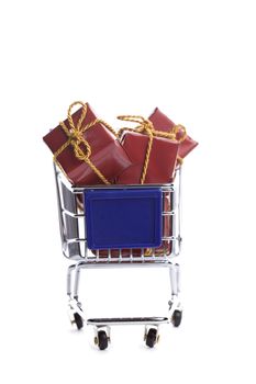 shopping cart full with christmas present box isolated on white background