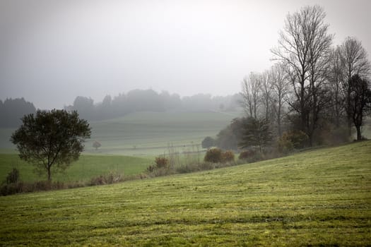 An image of a beautiful landscape with fog in bavaria germany