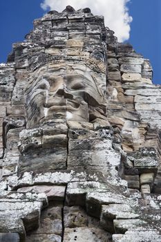 Image of Buddha's face carved on rock at UNESCO's World Heritage Site of Bayon, which is part of the larger temple complex of Angkor Thom, located at Siem Reap, Cambodia. This is one of the temples in Siem Reap where the Hollywood movie Lara Croft Tomb Raider was filmed at.