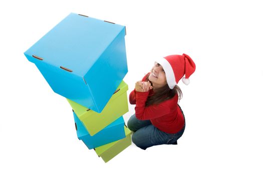 young santa woman in her knees near a pile of present boxes . isolated on white background.