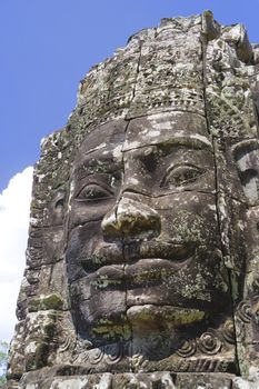 Image of Buddha's face at UNESCO's World Heritage Site of Bayon, which is part of the larger temple complex of Angkor Thom, located at Siem Reap, Cambodia. This is one of the temples in Siem Reap where the Hollywood movie Lara Croft Tomb Raider was filmed at.