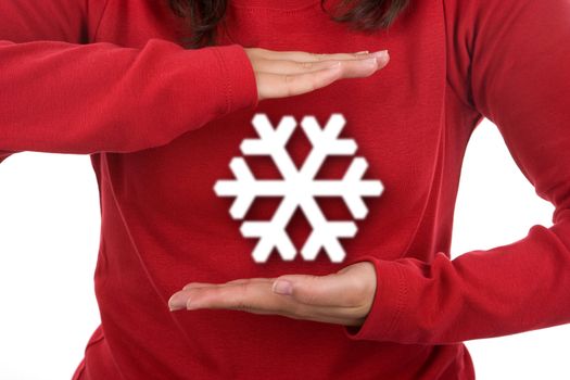 santa woman in red shirt celebrating christmas holding giant snowflake. landscape orientation.