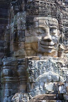 Image of Buddha's face at UNESCO's World Heritage Site of Bayon, which is part of the larger temple complex of Angkor Thom, located at Siem Reap, Cambodia. This is one of the temples in Siem Reap where the Hollywood movie Lara Croft Tomb Raider was filmed at.