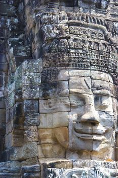 Image of Buddha's face at UNESCO's World Heritage Site of Bayon, which is part of the larger temple complex of Angkor Thom, located at Siem Reap, Cambodia. This is one of the temples in Siem Reap where the Hollywood movie Lara Croft Tomb Raider was filmed at.